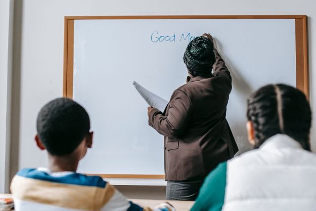 a teacher writing on board
