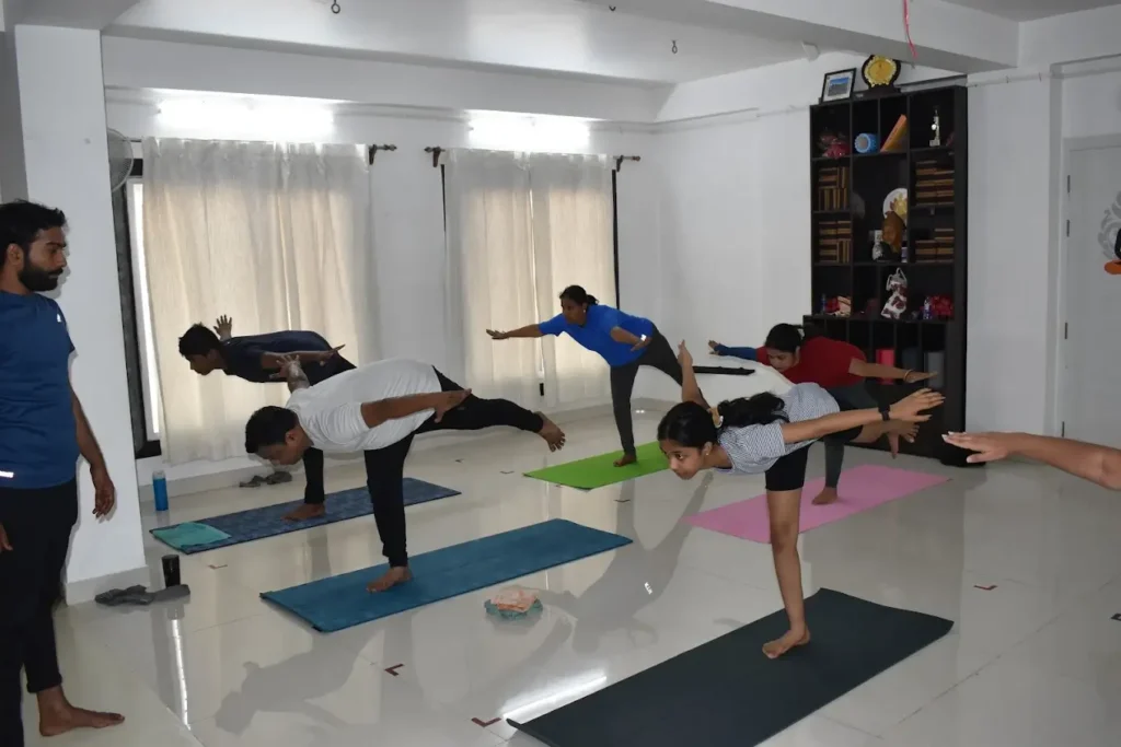 individuals performing yoga poses