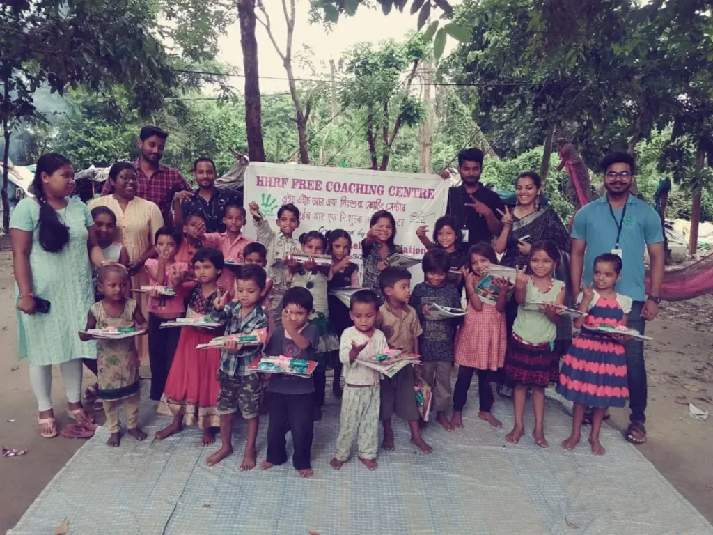 volunteers distributing stationary products to yound children