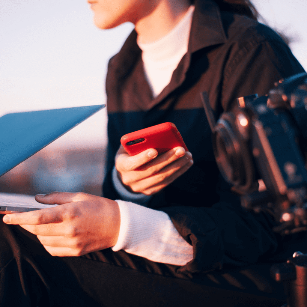 a woman working on laptop and phone