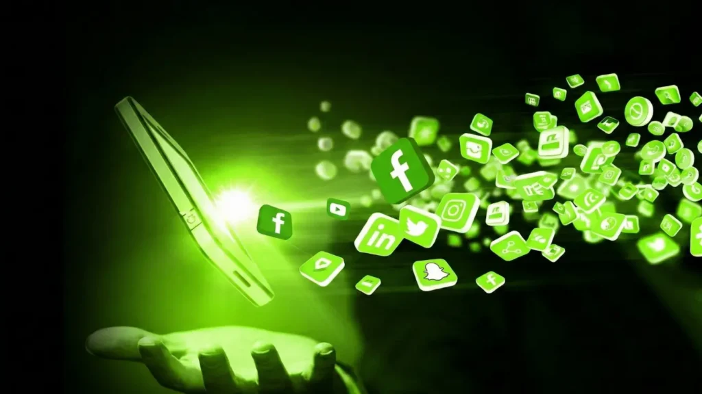A hand is holding a smartphone, and a stream of green glowing social media app icons, including Facebook, LinkedIn, and Instagram, are floating out from its screen.
