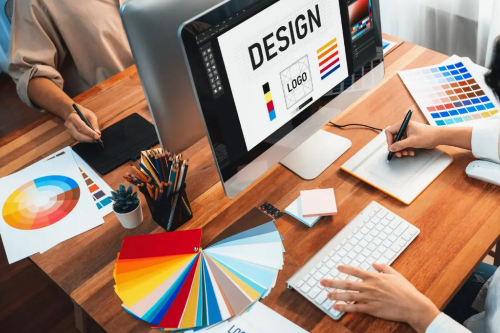 Freelance graphic designer creating social media posts and logos on laptop