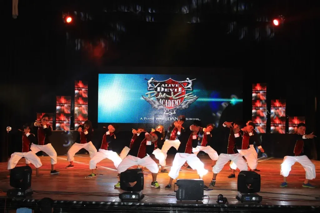 a group of students of a dance academy, performing on stage
