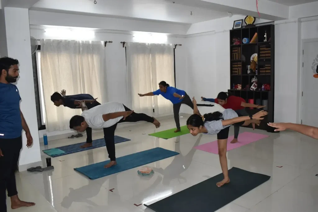 individuals performing yoga poses