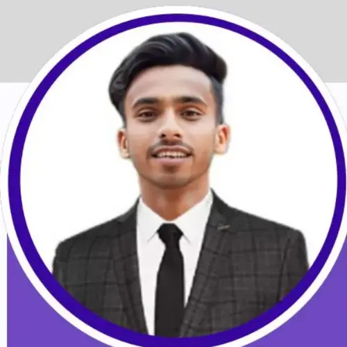 A professional headshot of a smiling young man with styled dark hair, wearing a dark suit and tie, framed within a circular purple border.