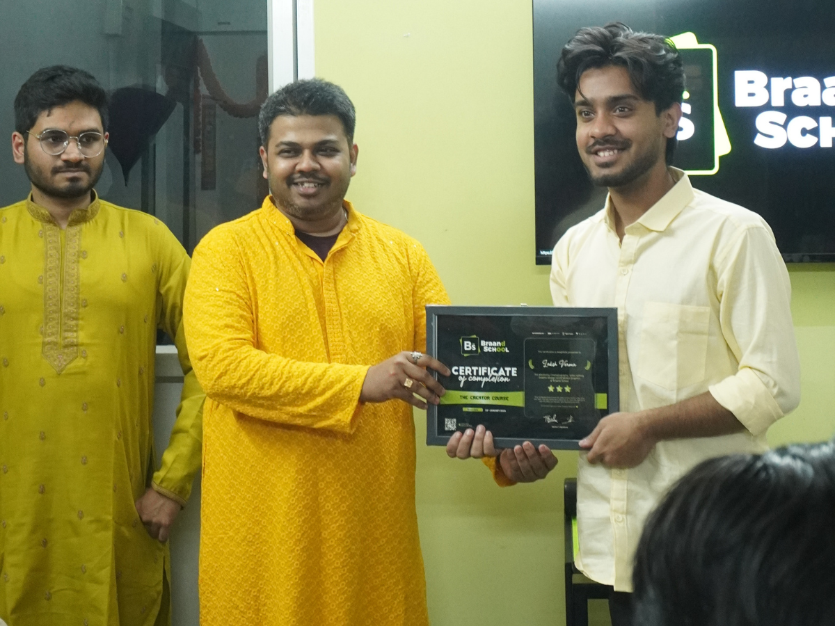 Student Laksh Verma posing with his certificate and a mentor in a yellow kurta during the graduation ceremony.