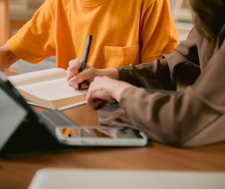 Home tutor teaching students in small coaching class setup