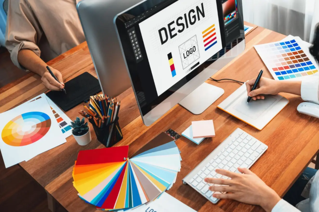 Freelance graphic designer creating social media posts and logos on laptop